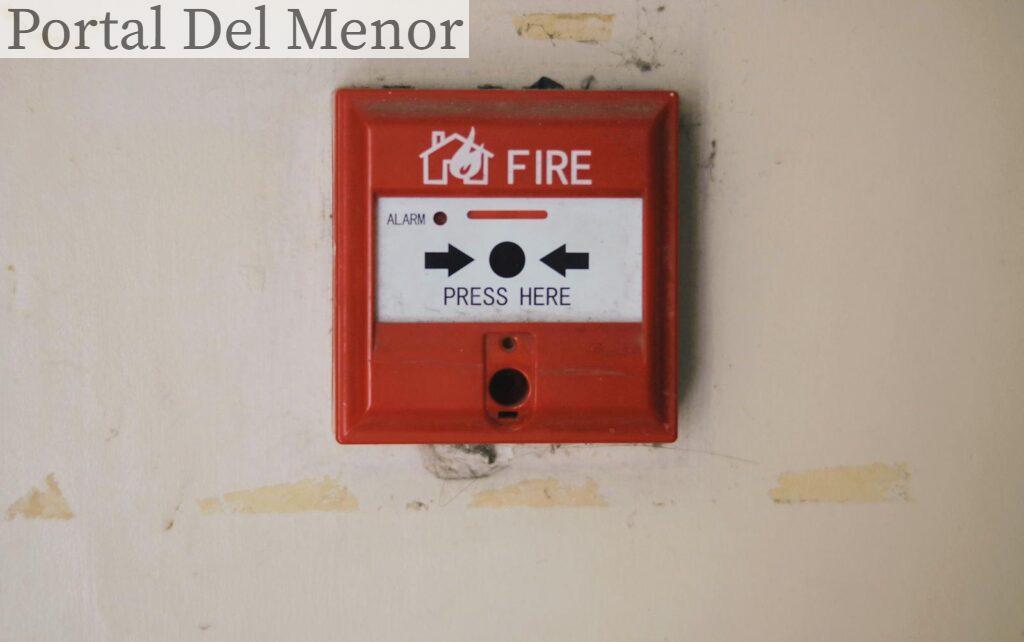Emergency safety fire detection system box for safety with inscription and push button placed on white wall in light room
