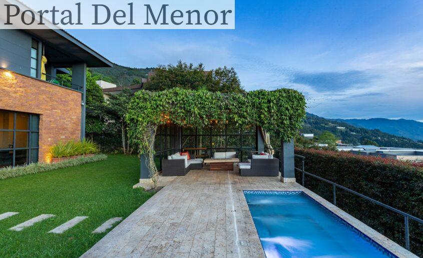 a house with a swimming pool in front of it