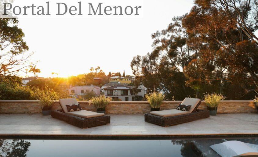 a pool with two lounge chairs and a view of a house
