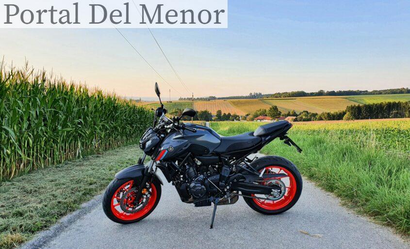 black and red naked motorcycle parked on gray asphalt road during daytime